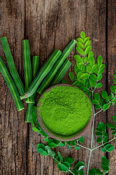 Moringa oleifera powder, Drumstick leaf powder on wooden background